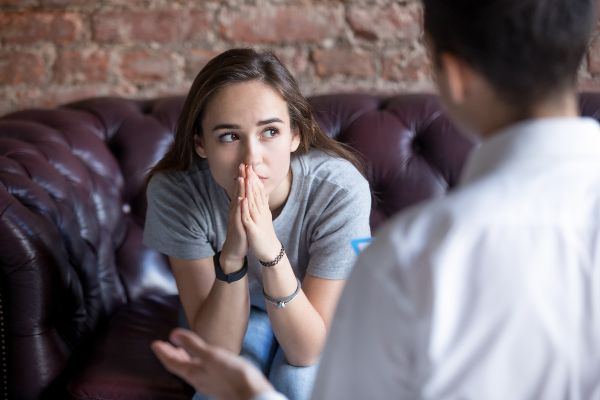 A teenage girl talking with a counselor